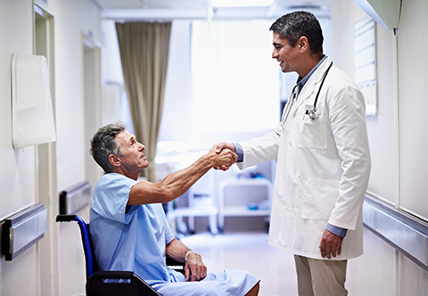 Physician shaking hand of patient in a hospital