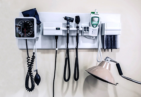 Medical instruments on an exam room wall