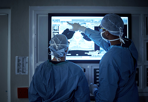 Surgeons reviewing an x-ray